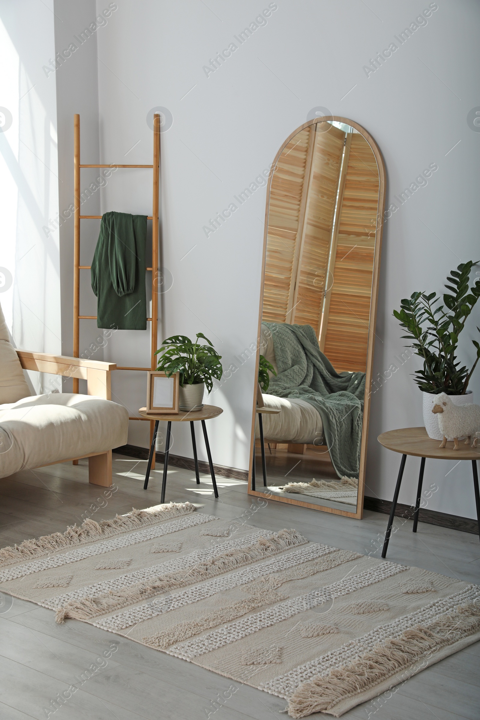 Photo of Stylish room interior with leaning floor mirror