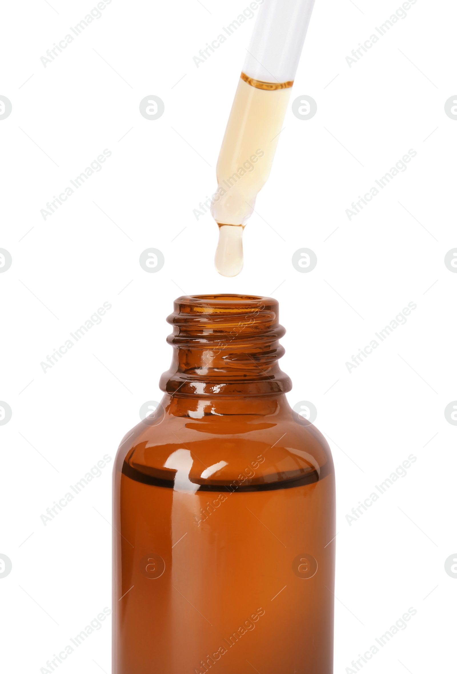 Photo of Brown bottle and dropper with essential oil on white background