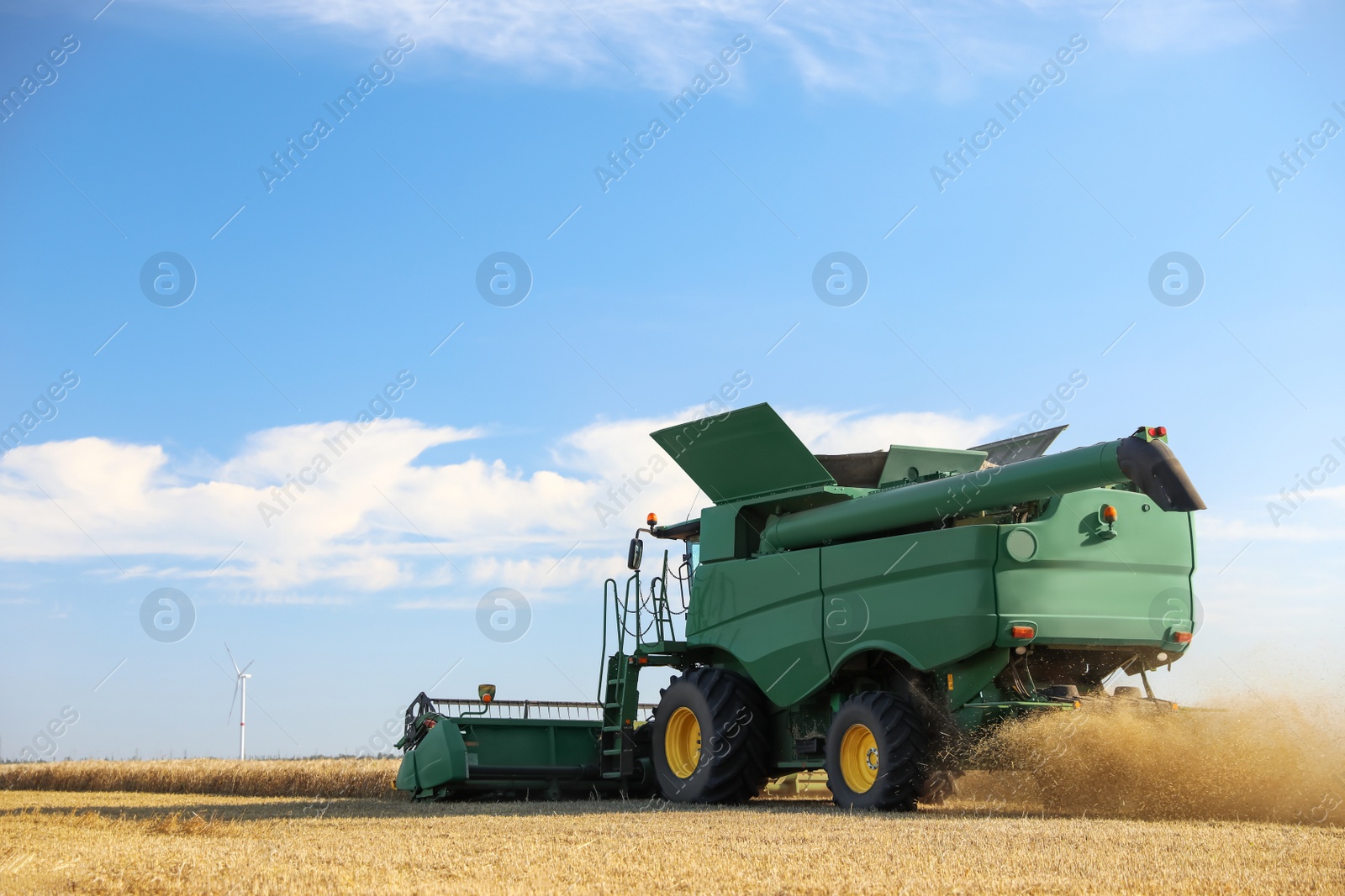 Photo of Modern combine harvester working in agricultural field