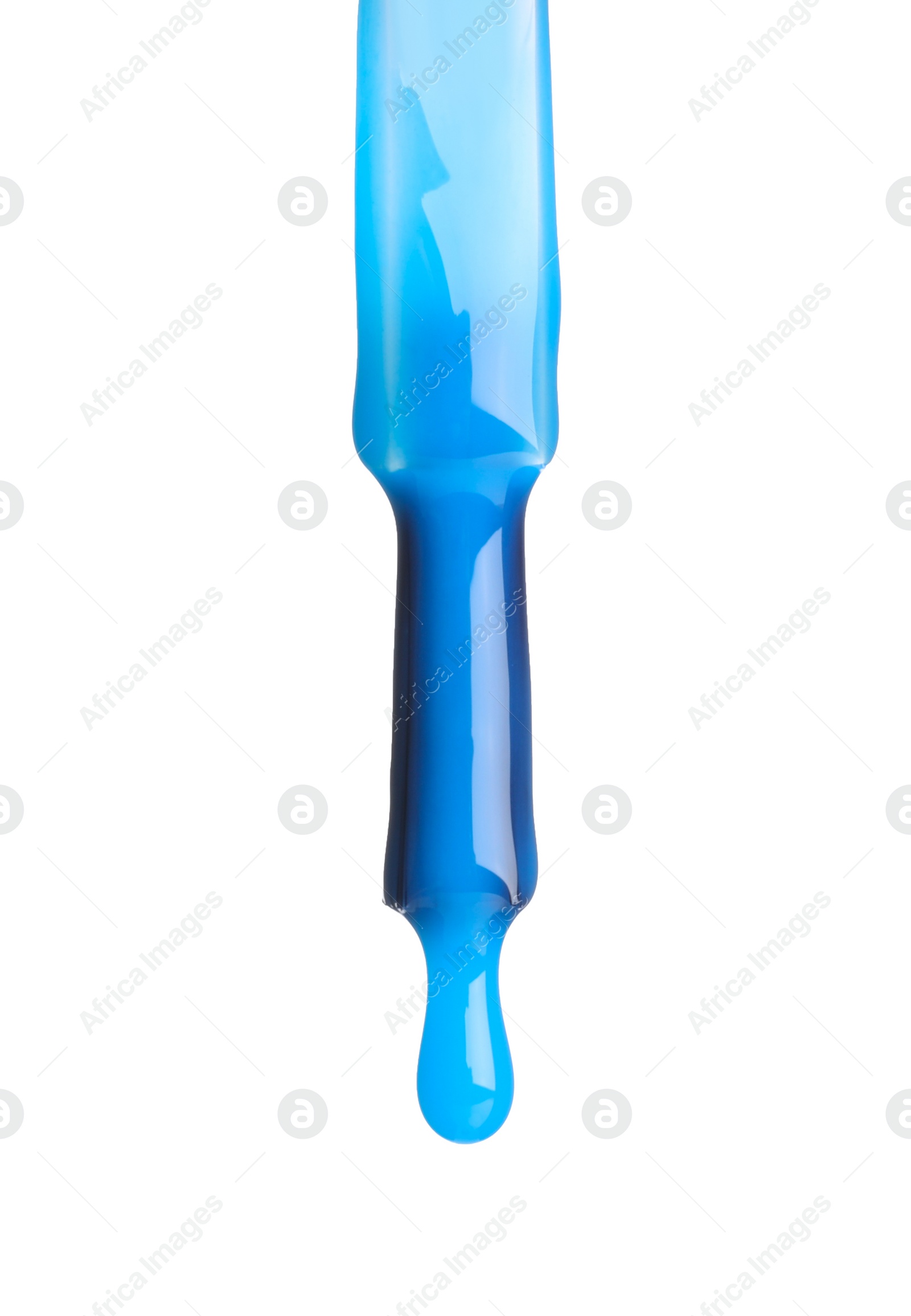 Photo of Blue nail polish dripping from brush isolated on white