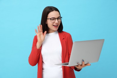 Photo of Happy young intern having online meeting on light blue background