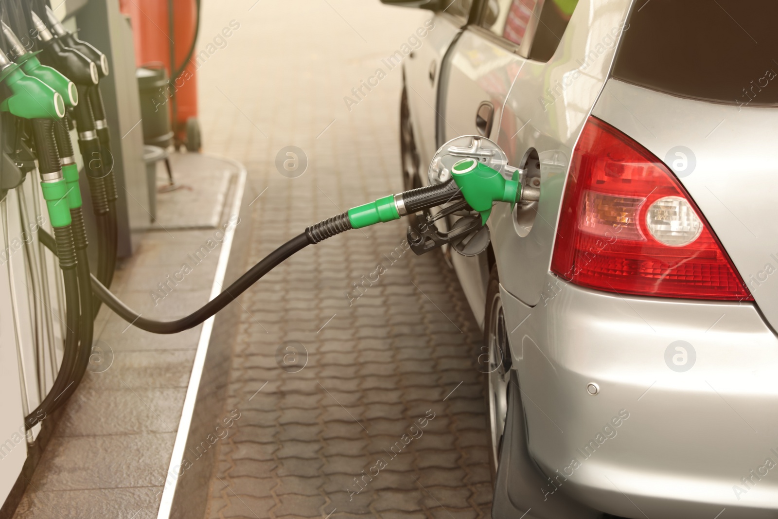 Photo of Refueling modern car at gas filling station, closeup