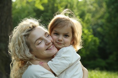 Happy woman with her daughter spending time together outdoors