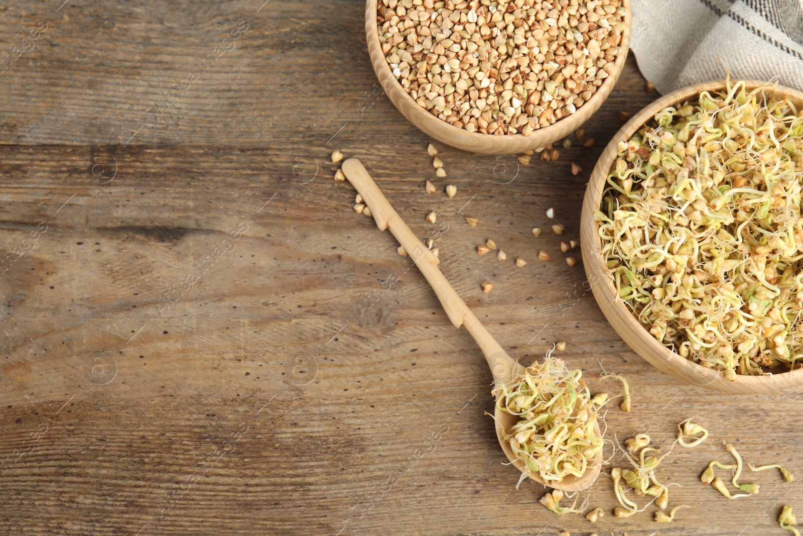 Photo of Flat lay composition with green buckwheat on wooden table, space for text