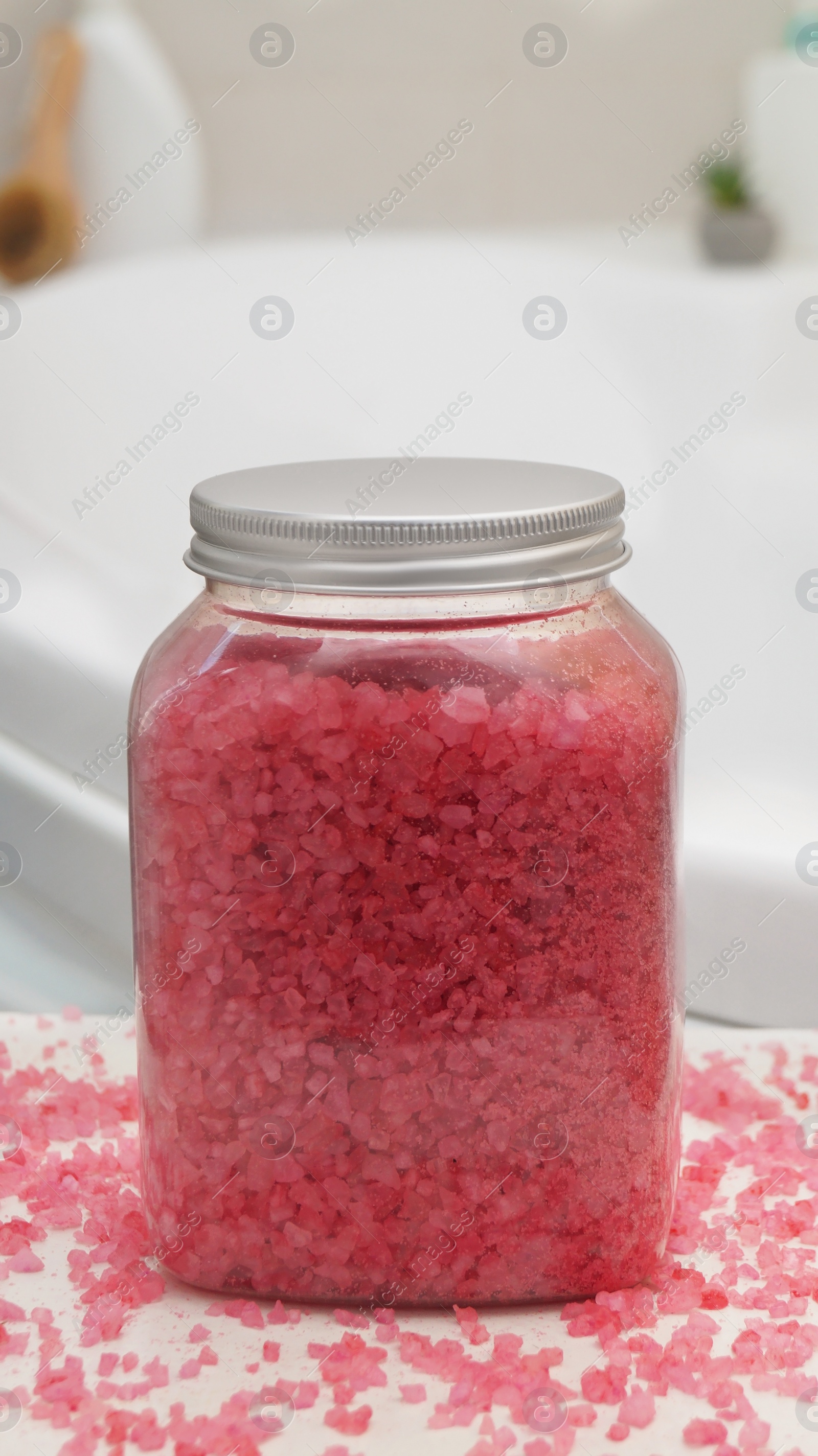 Jar with bath salt on table in bathroom Photo of Jar with bath salt on table in bathroom