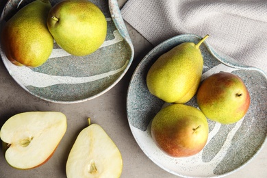 Composition with ripe juicy pears on grey stone table, flat lay