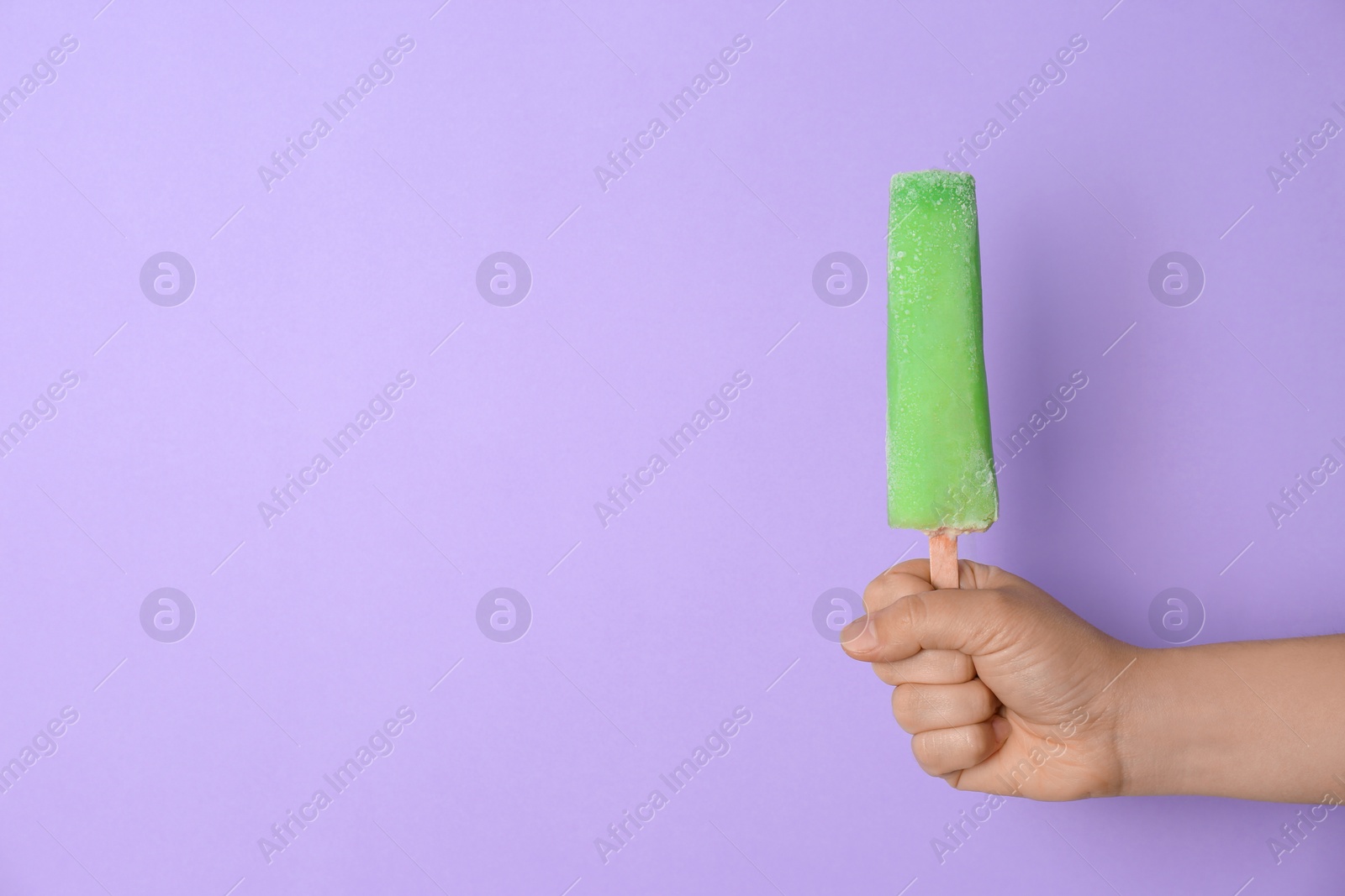 Photo of Woman holding delicious ice cream against color background, space for text