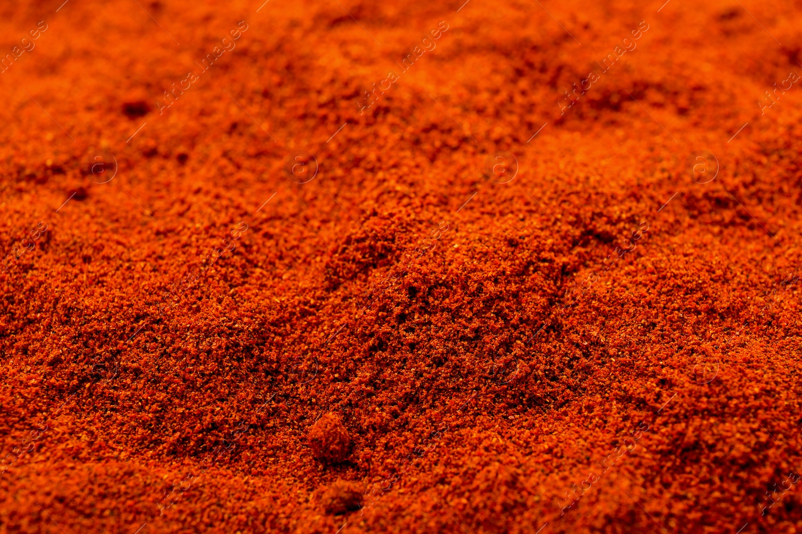 Photo of Aromatic paprika powder as background, closeup view