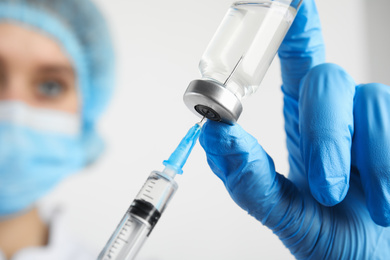 Doctor filling syringe with medication, closeup. Vaccination and immunization