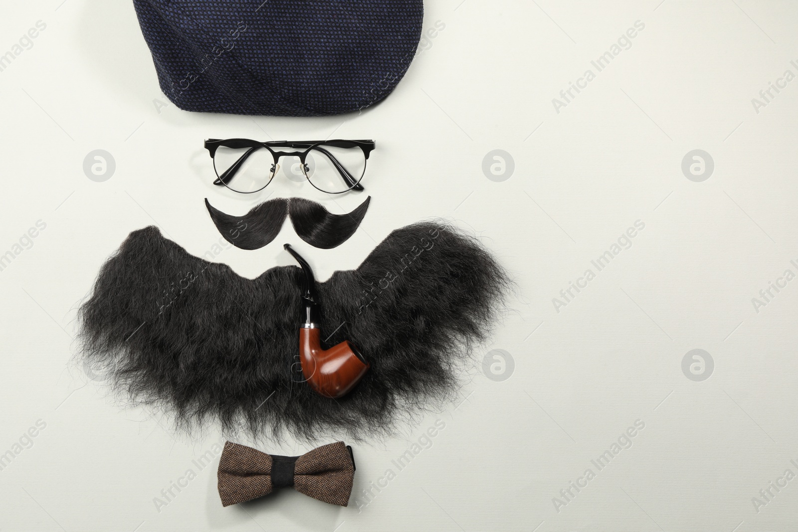 Photo of Flat lay composition with artificial moustache and glasses on light grey background, space for text