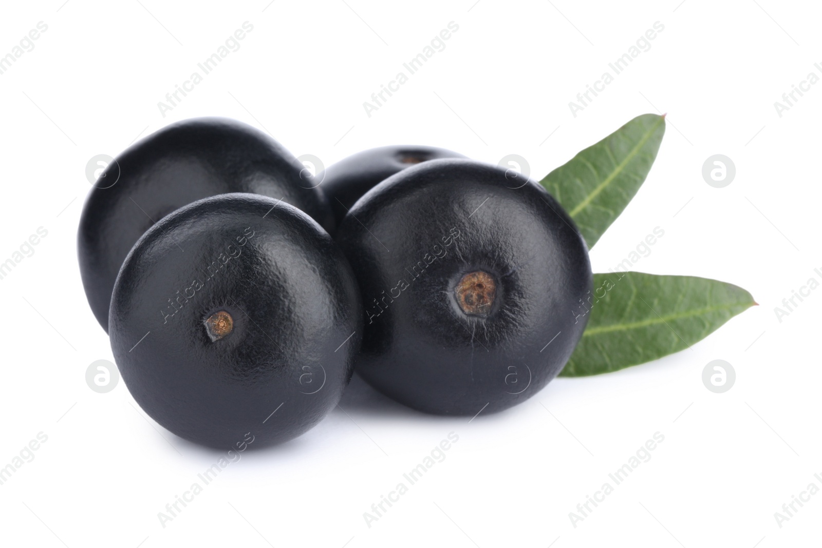 Photo of Pile of fresh ripe acai berries and green leaves on white background