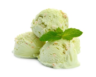 Scoops of delicious pistachio ice cream with mint on white background