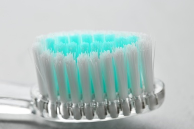 Manual toothbrush on gray background, close up