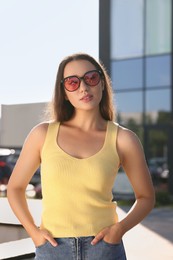 Beautiful woman in sunglasses on city street