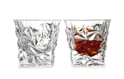 Photo of Empty and full whiskey glasses on white background