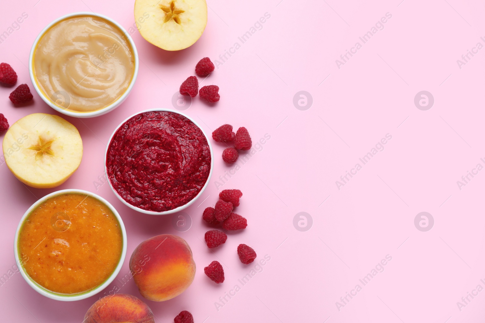 Photo of Different puree in bowls and fresh ingredients on pink background, flat lay. Space for text