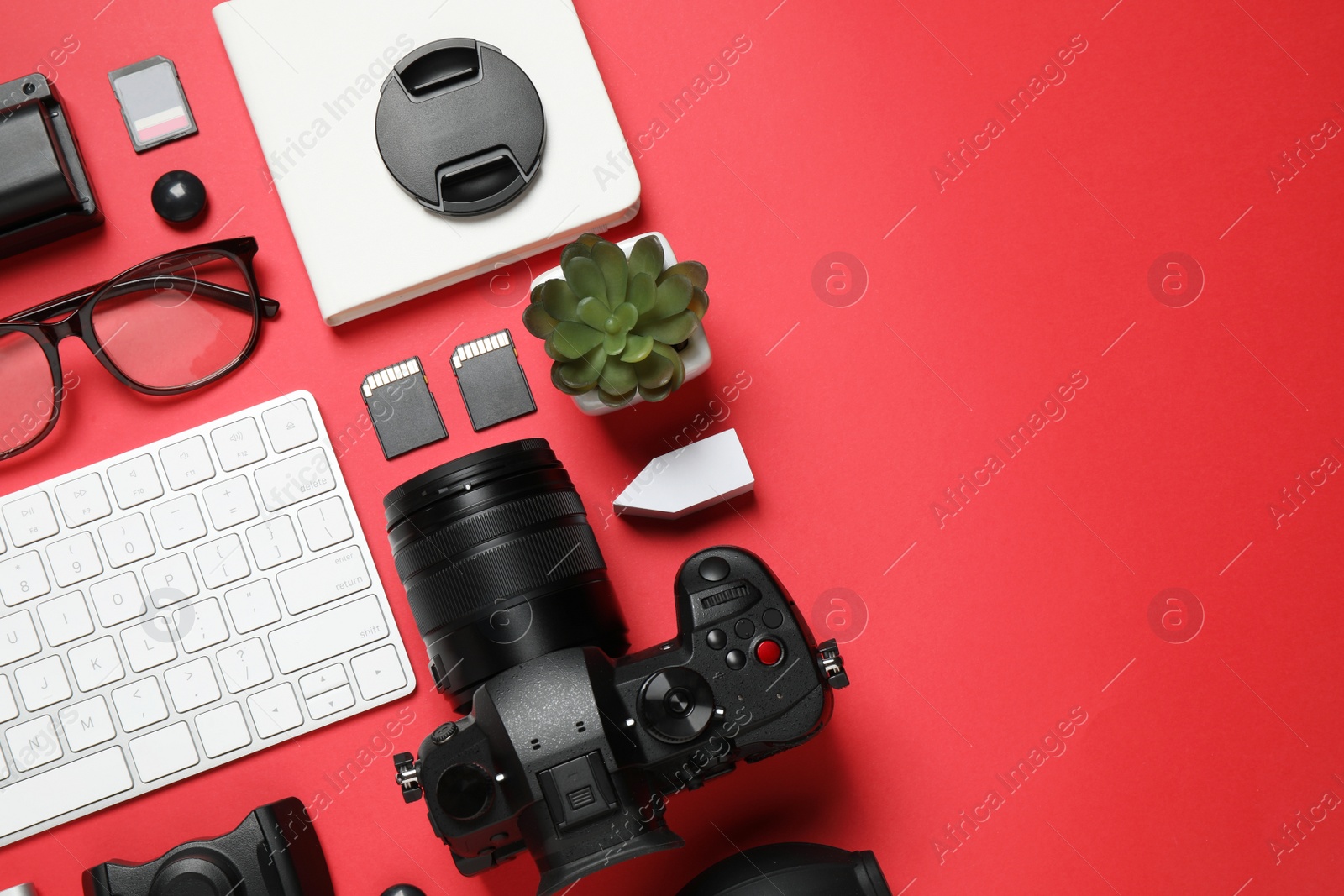 Photo of Flat lay composition with camera and video production equipment on red background. Space for text