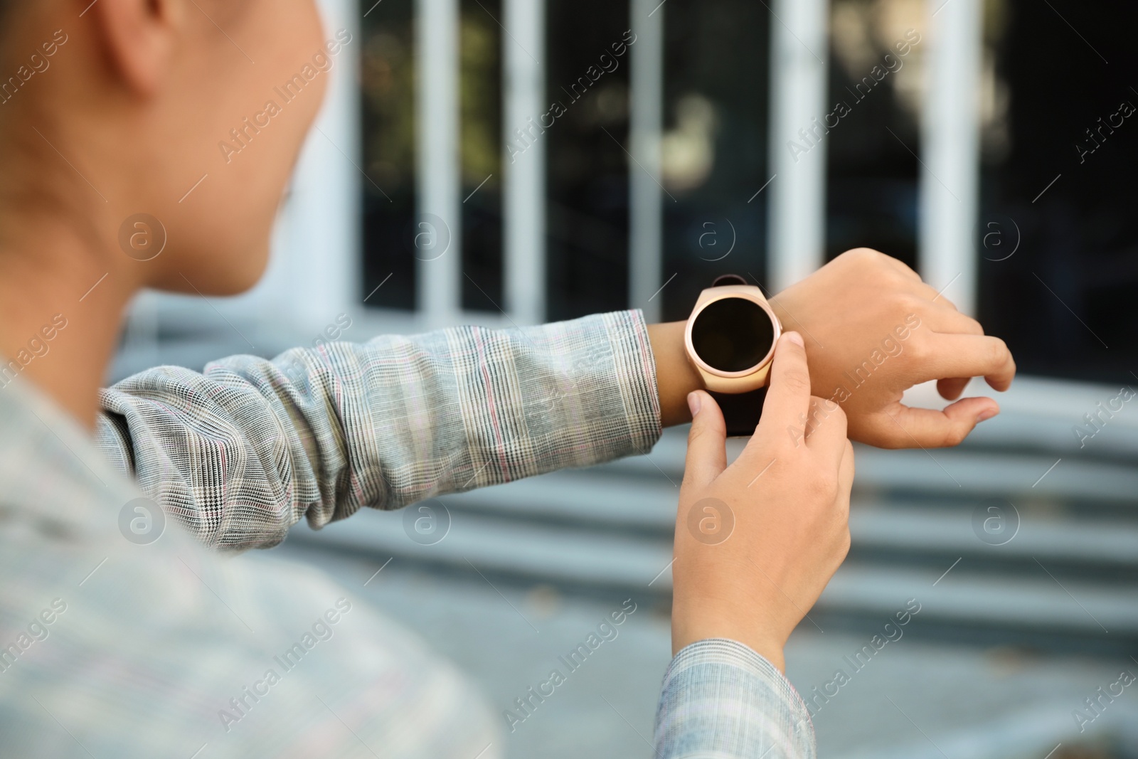 Photo of Young woman with smart watch outdoors, closeup