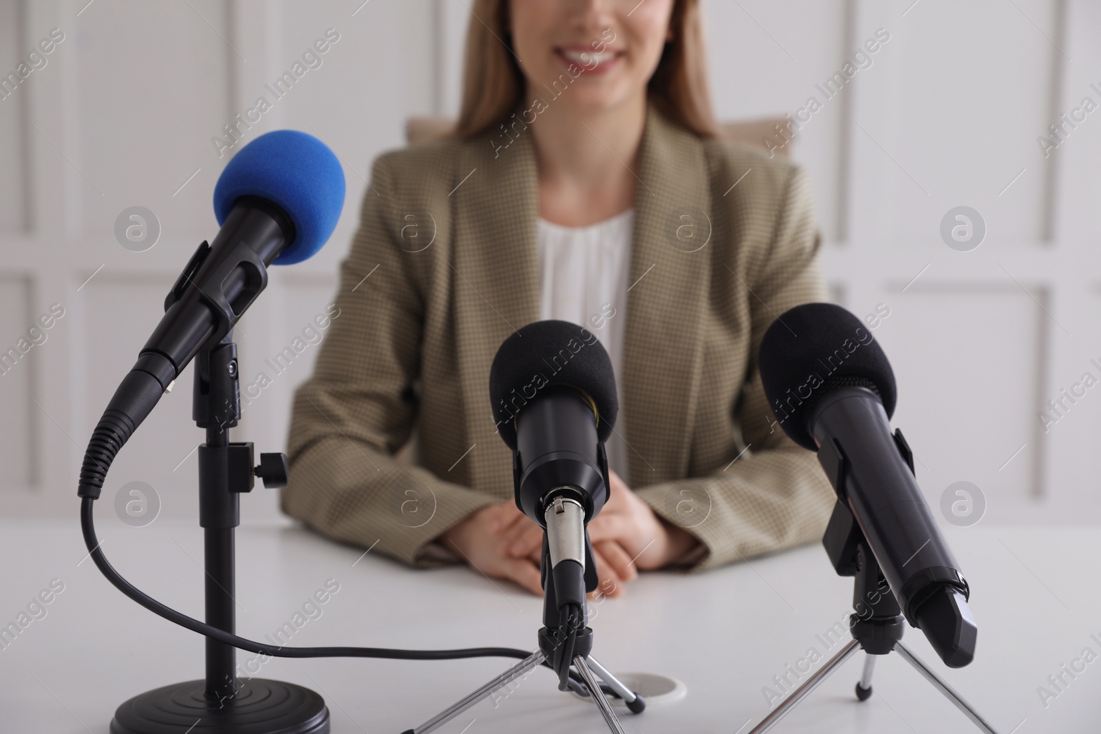 Photo of Happy young woman giving interview at official event, closeup