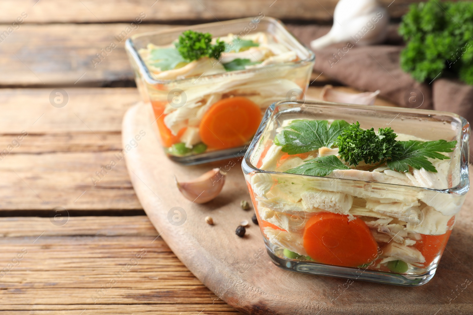 Photo of Delicious chicken aspic served on wooden table, closeup