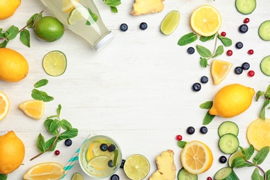 Photo of Flat lay composition with delicious natural lemonade on wooden background
