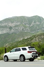 Beautiful view of mountains and car on roadside outdoors. Road trip