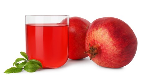 Photo of Refreshing pomegranate juice in glass, leaves and fruits isolated on white