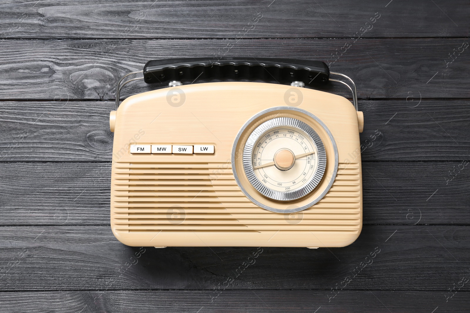 Photo of Old retro radio on black wooden background