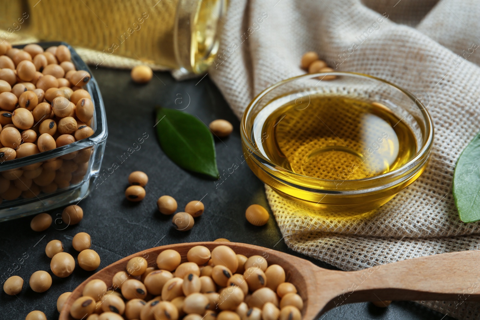 Photo of Composition with soybean oil on grey table