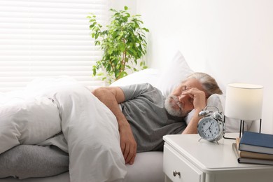 Photo of Senior man sleeping in bed at home