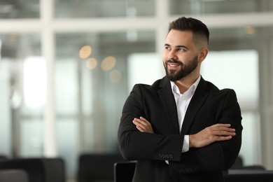 Photo of Portrait of smiling man with crossed arms in office, space for text. Lawyer, businessman, accountant or manager