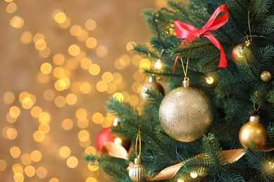 Photo of Beautiful Christmas tree with decor against blurred lights on background