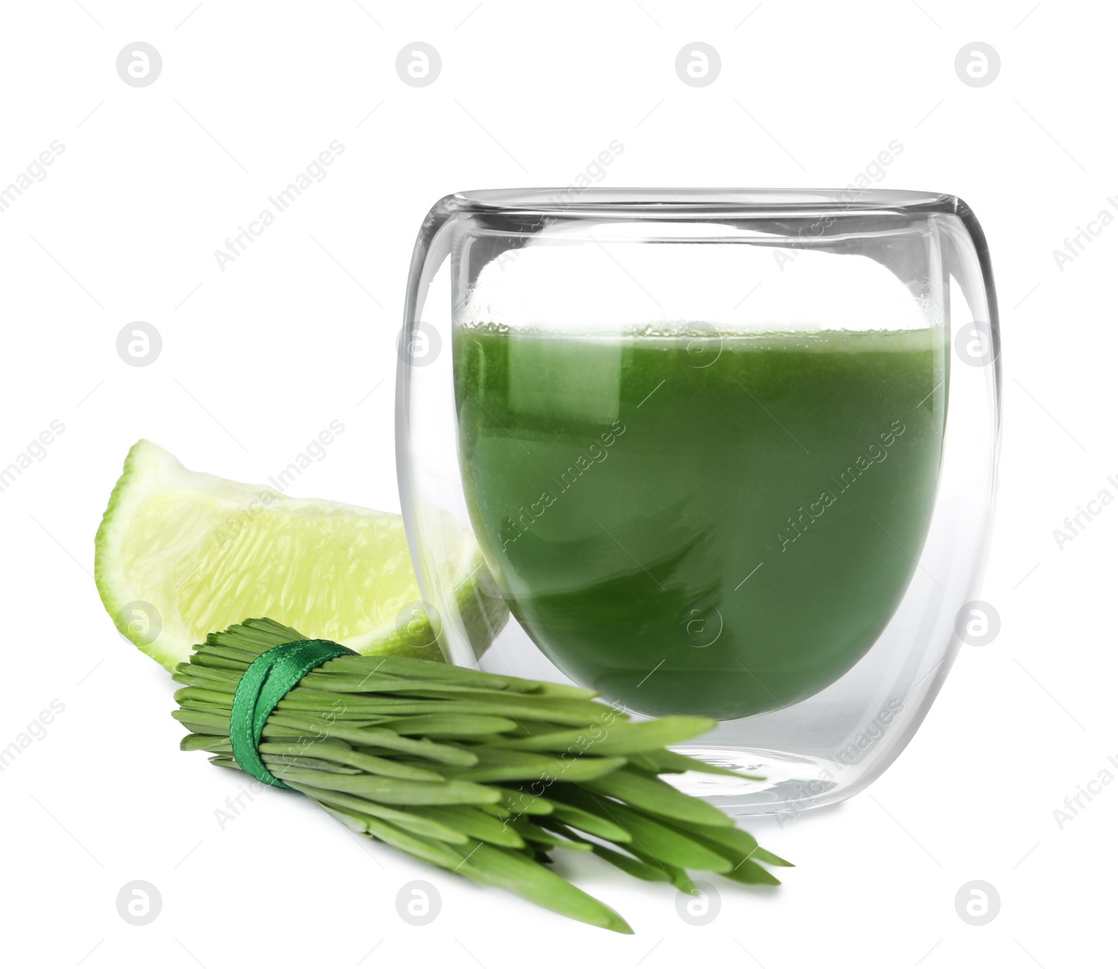 Fresh wheat grass juice in glass, slice of lime and sprouts on white background Photo of Fresh wheat grass juice in glass, slice of lime and sprouts on white background