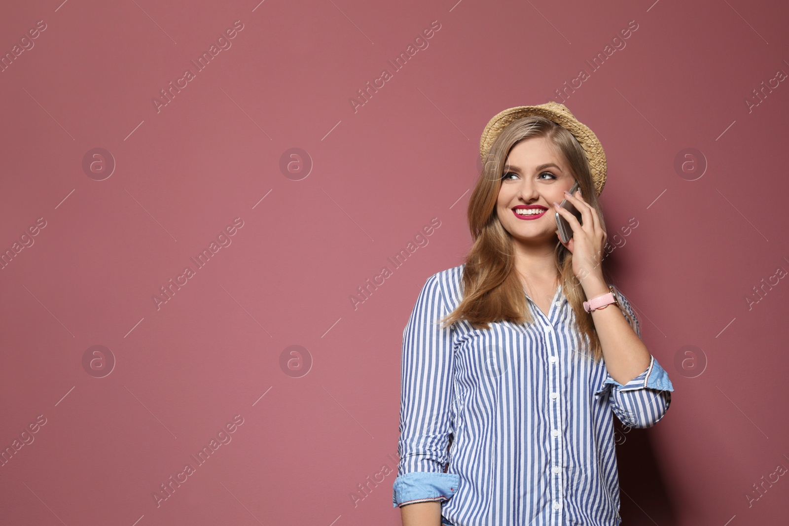 Photo of Attractive young woman talking on phone against color background