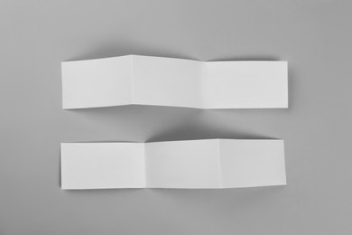 Photo of Blank paper brochures on light grey background, flat lay. Mockup for design