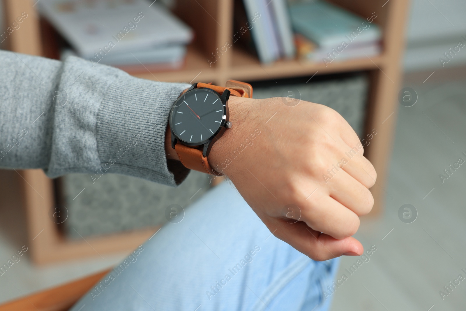 Photo of Man checking time in room, closeup. Being late