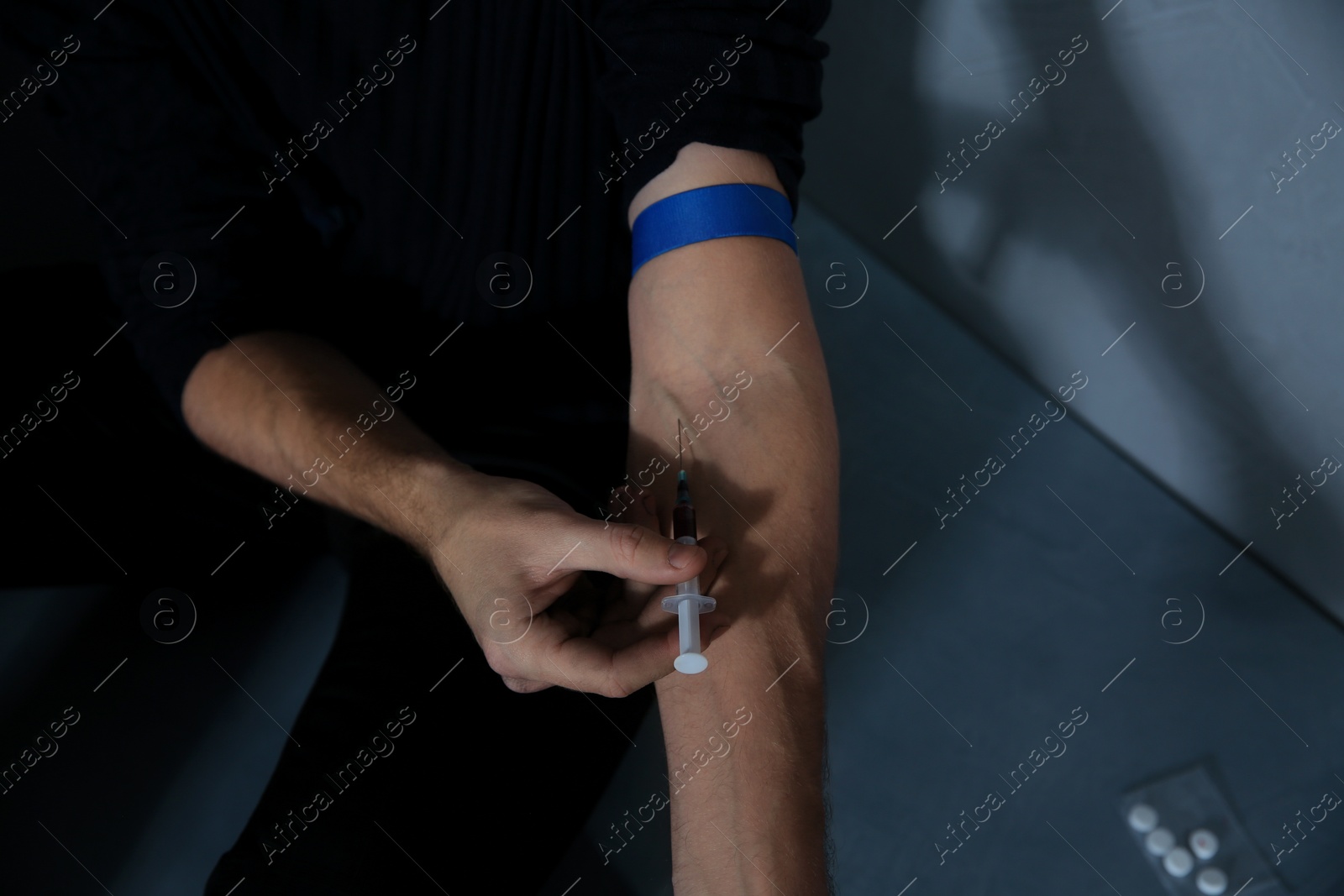 Photo of Male drug addict making injection, closeup of hands