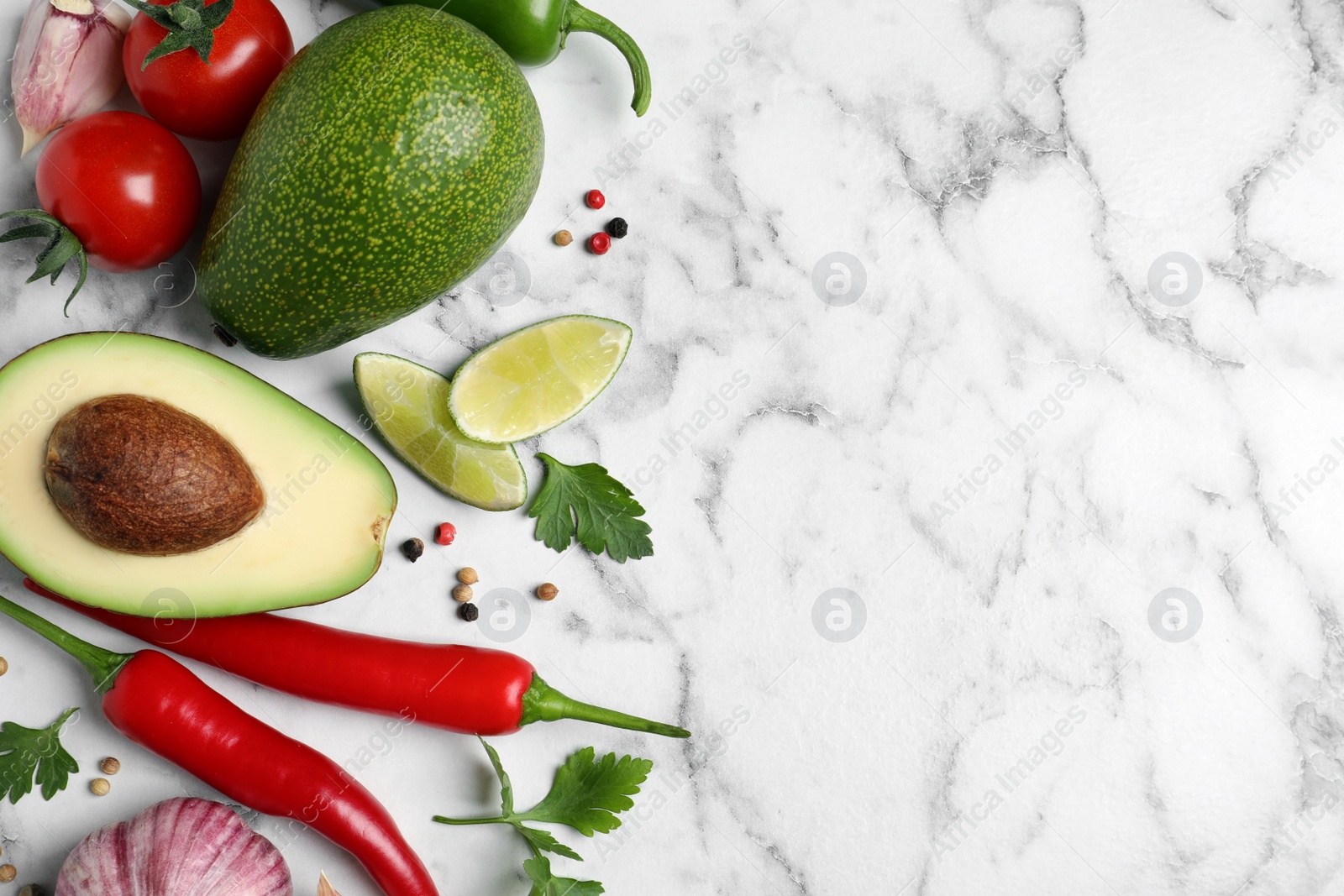 Photo of Fresh guacamole ingredients on white marble table, flat lay. Space for text