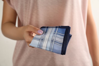 Photo of Woman holding handkerchief on white background, closeup