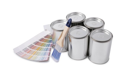 Photo of Cans of paints, brush and color palette on white background