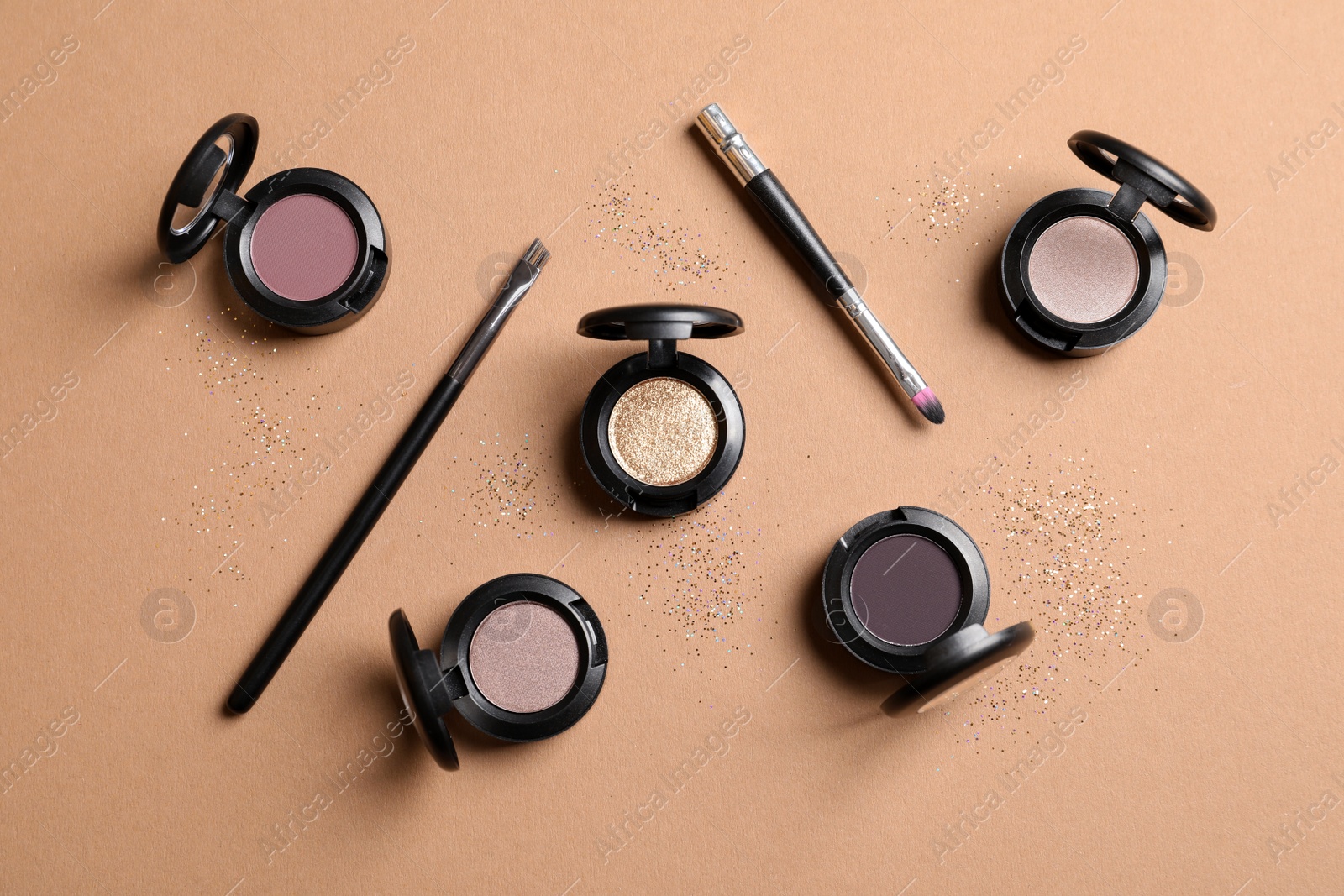 Photo of Flat lay composition with different eye shadows on color background