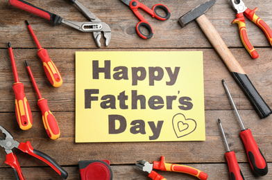 Photo of Flat lay composition with different tools and HAPPY FATHER'S DAY note on wooden background