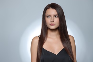 Beautiful young woman with healthy strong hair posing in studio