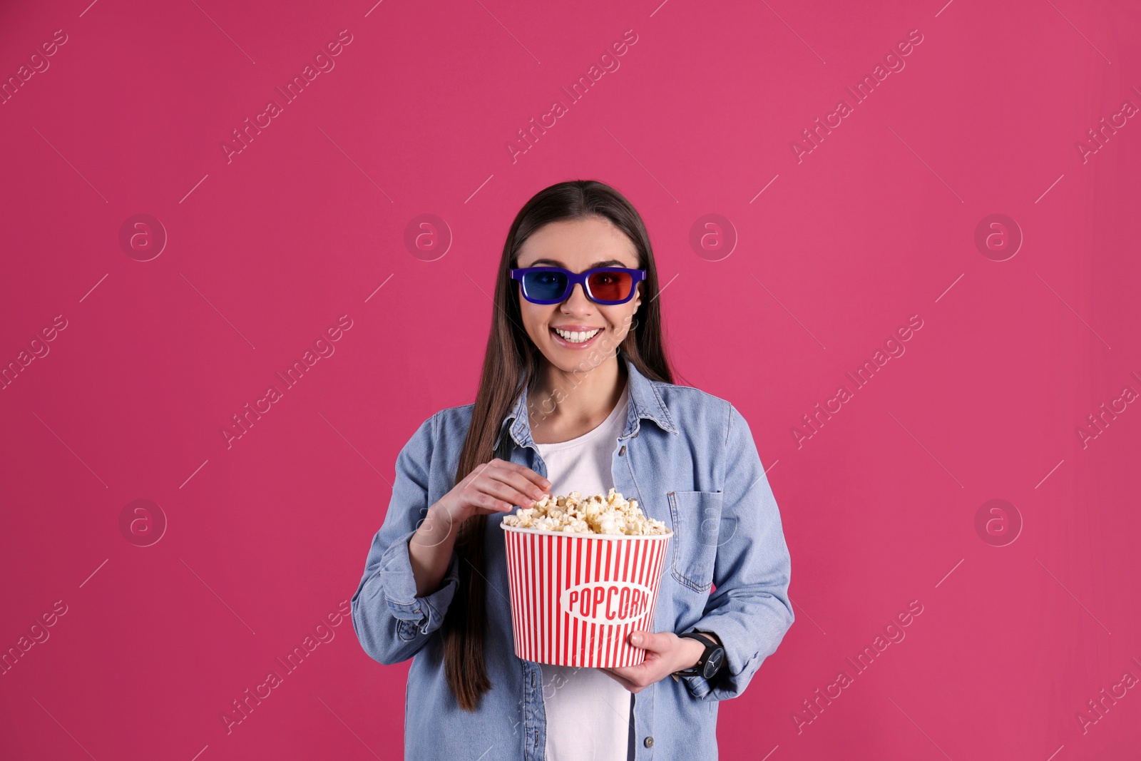 Photo of Young woman with 3D glasses and tasty popcorn on color background