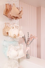 Photo of Luxury women's underwear on hangers in lingerie store