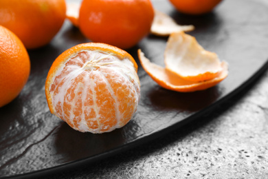 Photo of Fresh ripe tangerine on grey table. Space for text