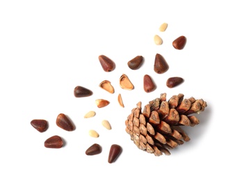 Photo of Composition with pine nuts and cone on white background, top view