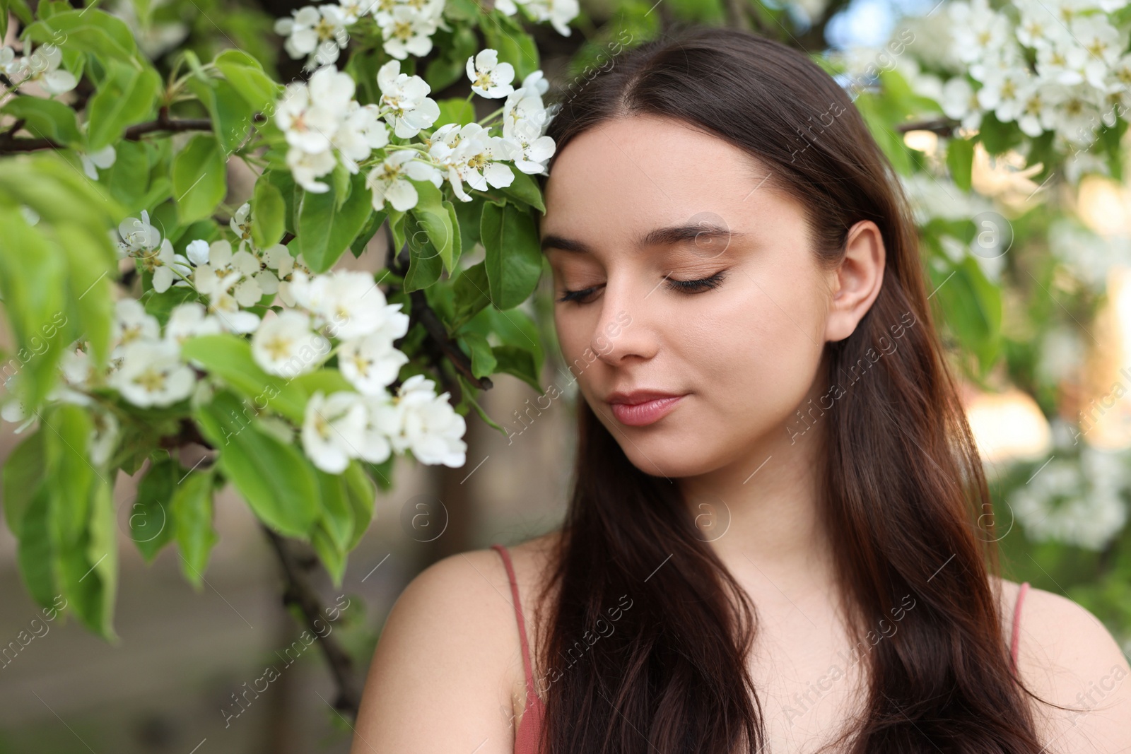 Photo of Beautiful woman near blossoming tree on spring day