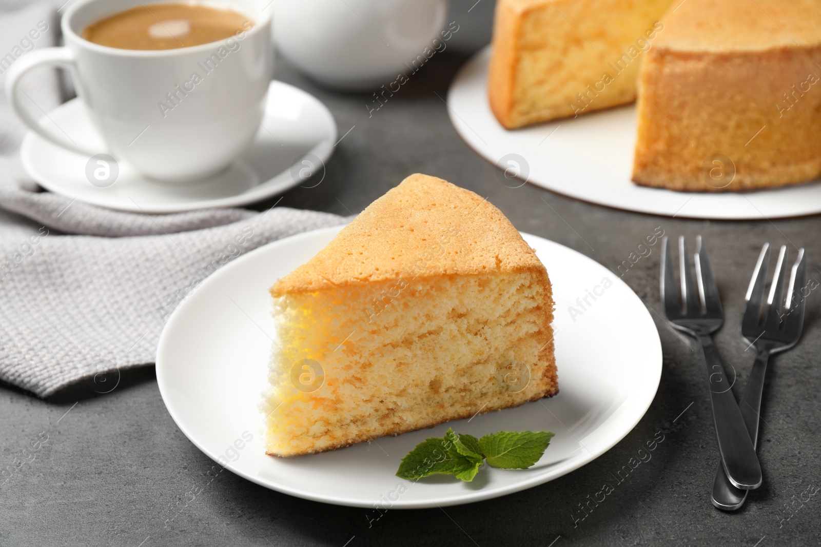 Photo of Piece of delicious fresh homemade cake served on grey table