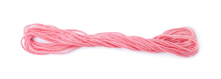 Bright pink embroidery thread on white background